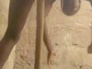 African woman masturbates with a broom handle.